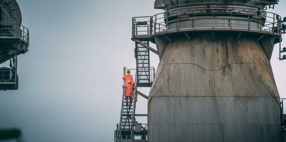 Two people working in orange coats